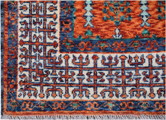 A handmade Afghan Chobi rug featuring a geometric Mamluk pattern in orange, blue, and cream.