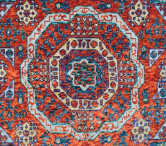 Handmade Afghan Chobi rug featuring a complex geometric medallion in red, blue, and cream tones.