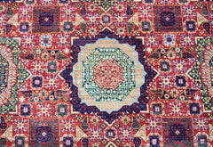 A handmade Afghan Chobi rug featuring a detailed Mamluk medallion pattern in red, blue, and gold.