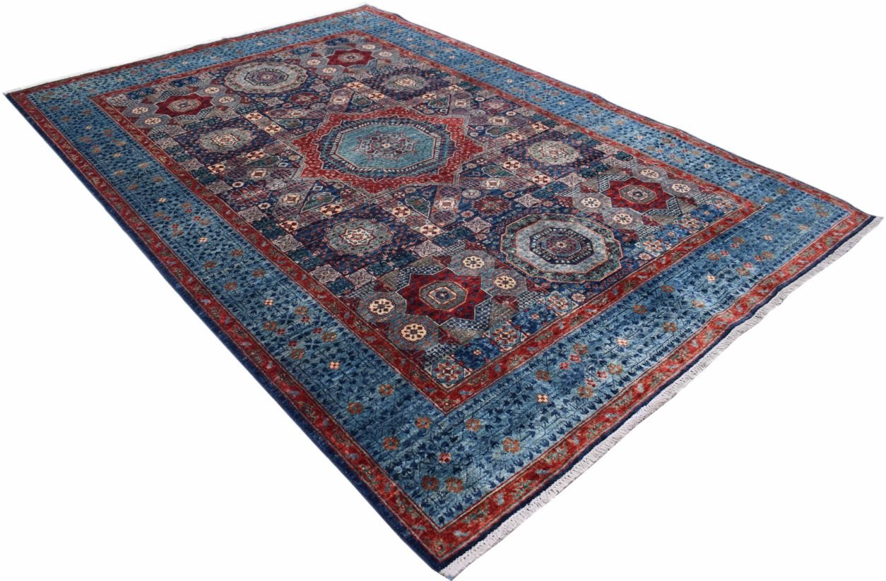 A handmade Afghan Chobi rug featuring a traditional Mamluk medallion design in blue and red wool.