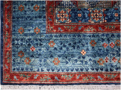 A handmade Afghan Chobi rug featuring a blue field with red borders and intricate floral motifs.