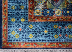 A handmade Afghan Chobi rug featuring a blue field with yellow floral motifs and a red border.