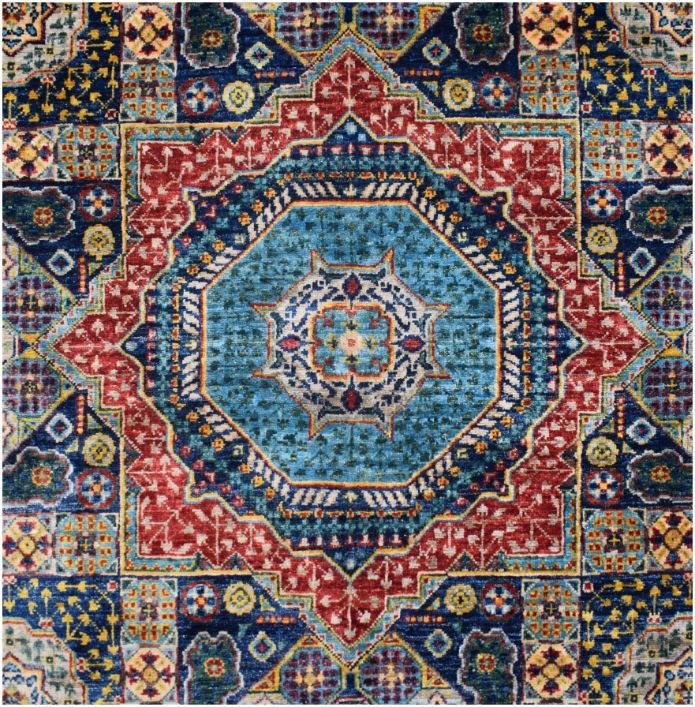 Handmade Afghan Chobi rug featuring a complex geometric medallion design in blue and red tones.