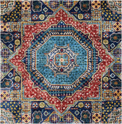 Handmade Afghan Chobi rug featuring a complex geometric medallion design in blue and red tones.