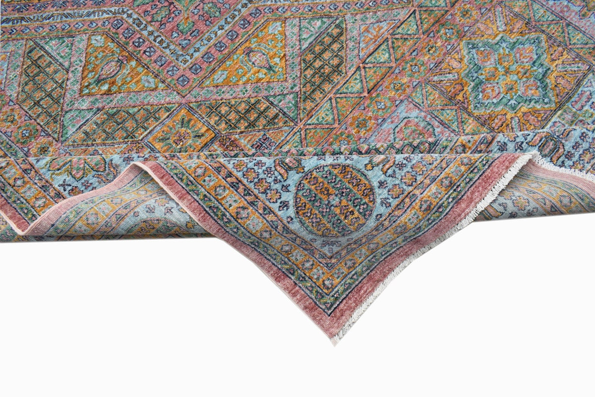 A handwoven Afghan Chobi rug featuring a geometric Mamluk pattern in muted earth tones.