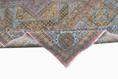 A handwoven Afghan Chobi rug featuring a geometric Mamluk pattern in muted earth tones.