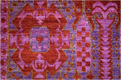 A handmade Afghan Chobi rug featuring a complex Mamluk medallion design in shades of red and purple.