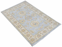 An Afghan Chobi rug featuring a light blue field with traditional floral patterns and a beige border.