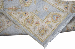 A handwoven Afghan Chobi rug featuring a traditional floral pattern in soft blue and beige tones.