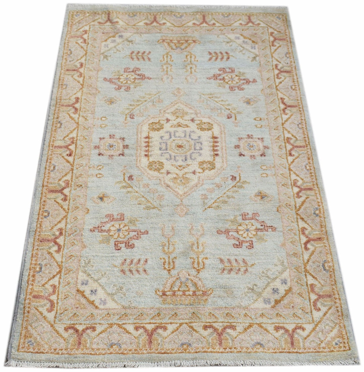A rectangular Afghan Chobi rug featuring a central medallion and floral motifs in soft pastel tones.