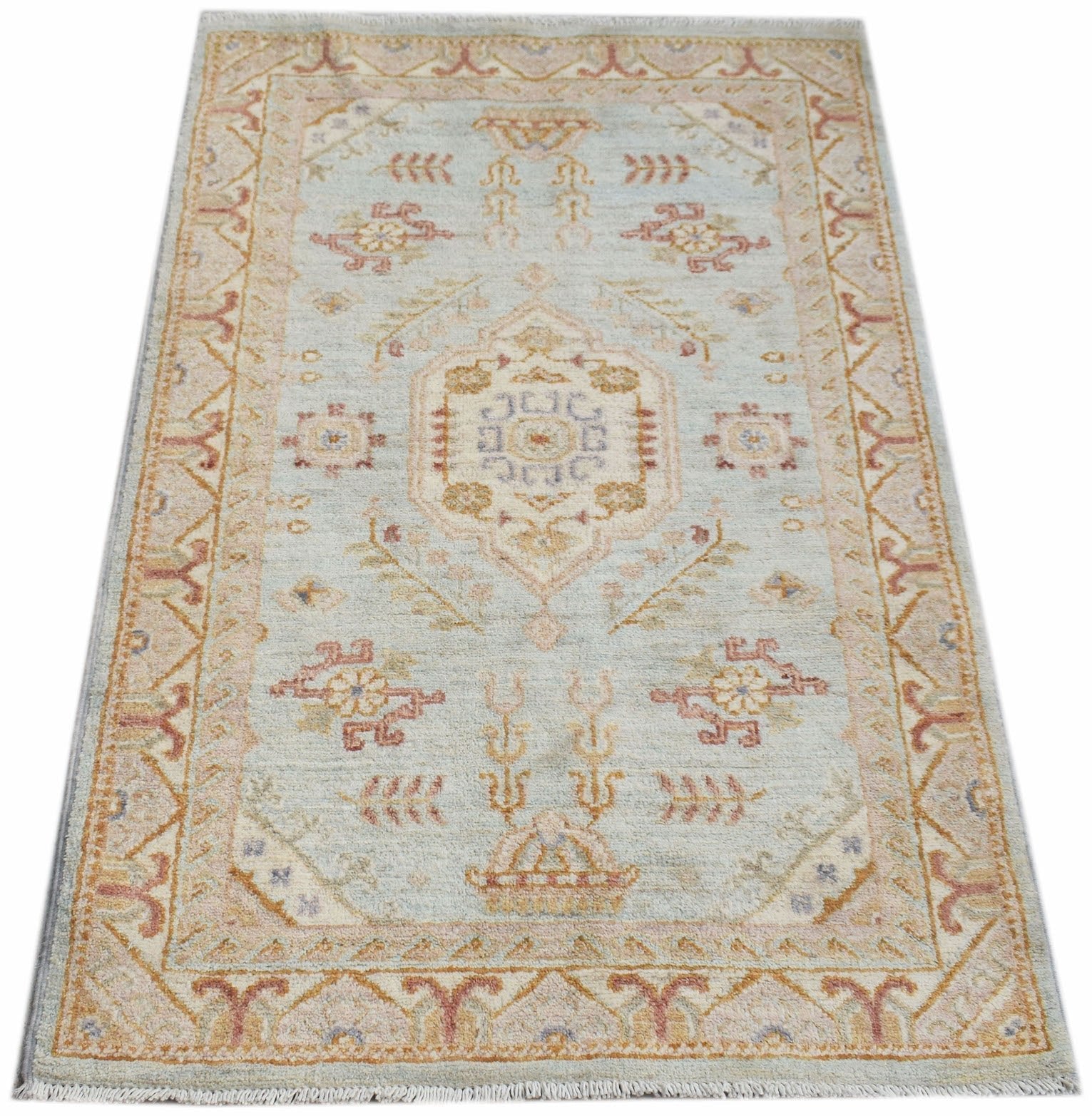 A rectangular Afghan Chobi rug featuring a central medallion and floral motifs in soft pastel tones.