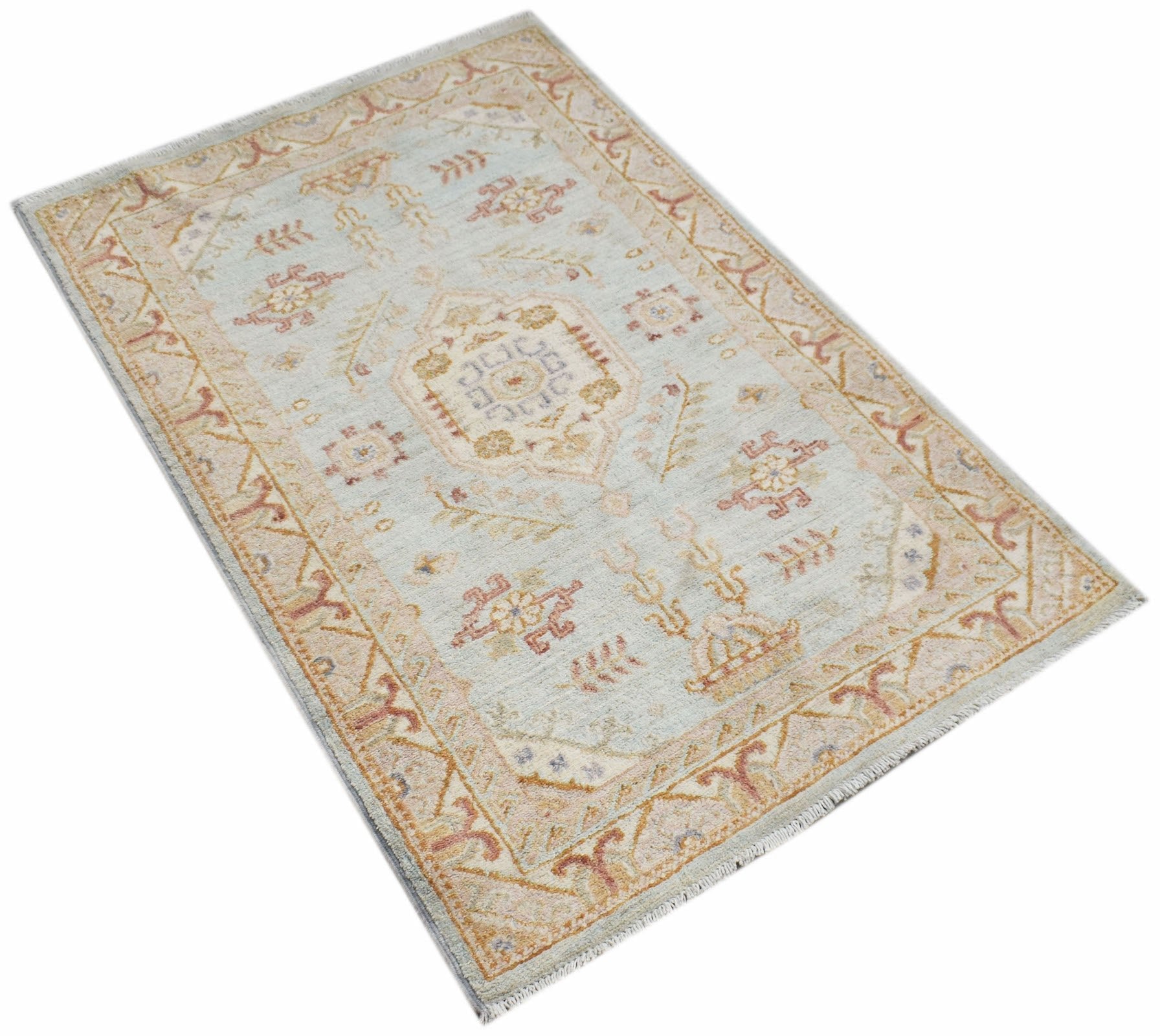 A rectangular Afghan Chobi rug featuring a central medallion on a light blue field with floral motifs.