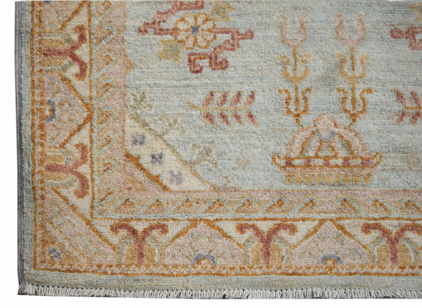 A handmade Afghan Chobi rug featuring traditional floral patterns in soft, earthy tones.