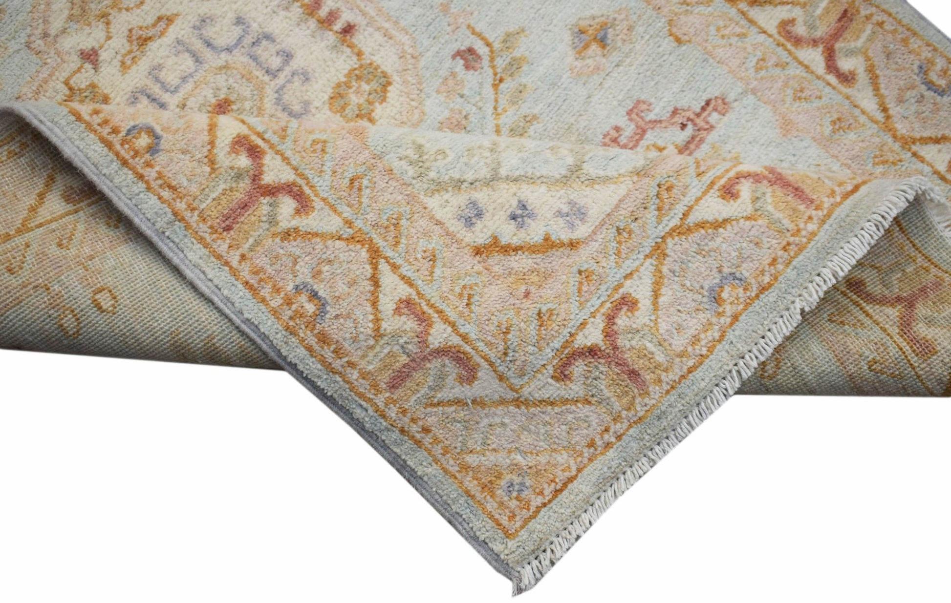 A handwoven Afghan Chobi rug featuring a traditional floral pattern in soft pastel tones.