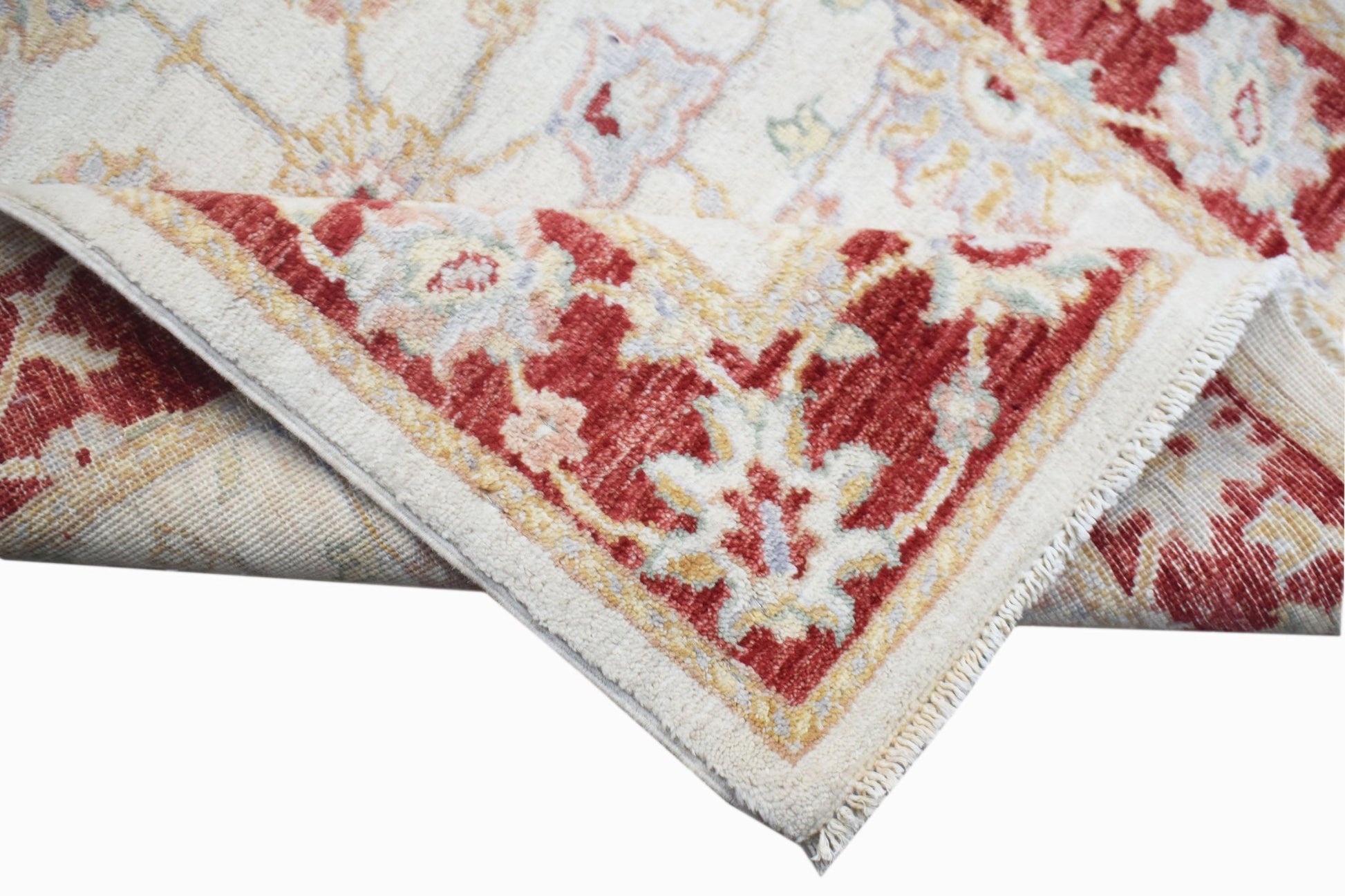 A handwoven Afghan Chobi rug featuring a traditional floral pattern in red and cream tones.