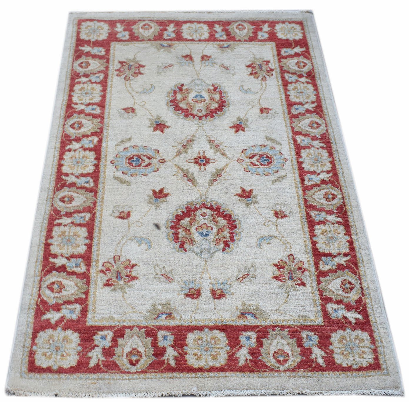 An Afghan Chobi rug featuring a traditional floral pattern in red and blue on a cream background.