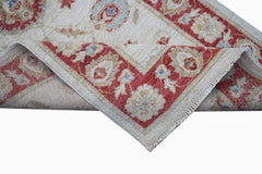 A handwoven Afghan Chobi rug featuring a traditional floral pattern in red, beige, and blue.