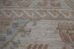 A close-up view of a handwoven Afghan Chobi rug featuring traditional patterns in earthy tones.