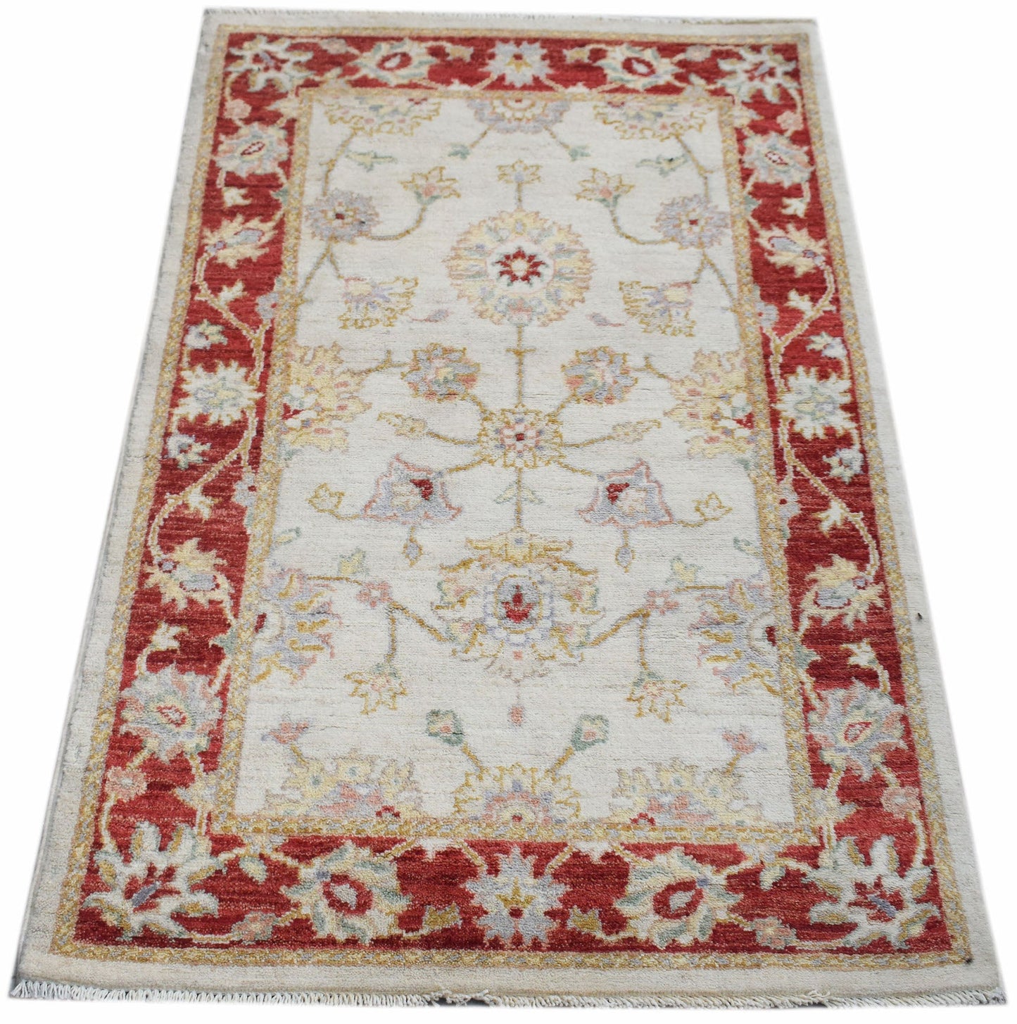 A rectangular Afghan Chobi rug featuring a floral pattern in red and cream tones.