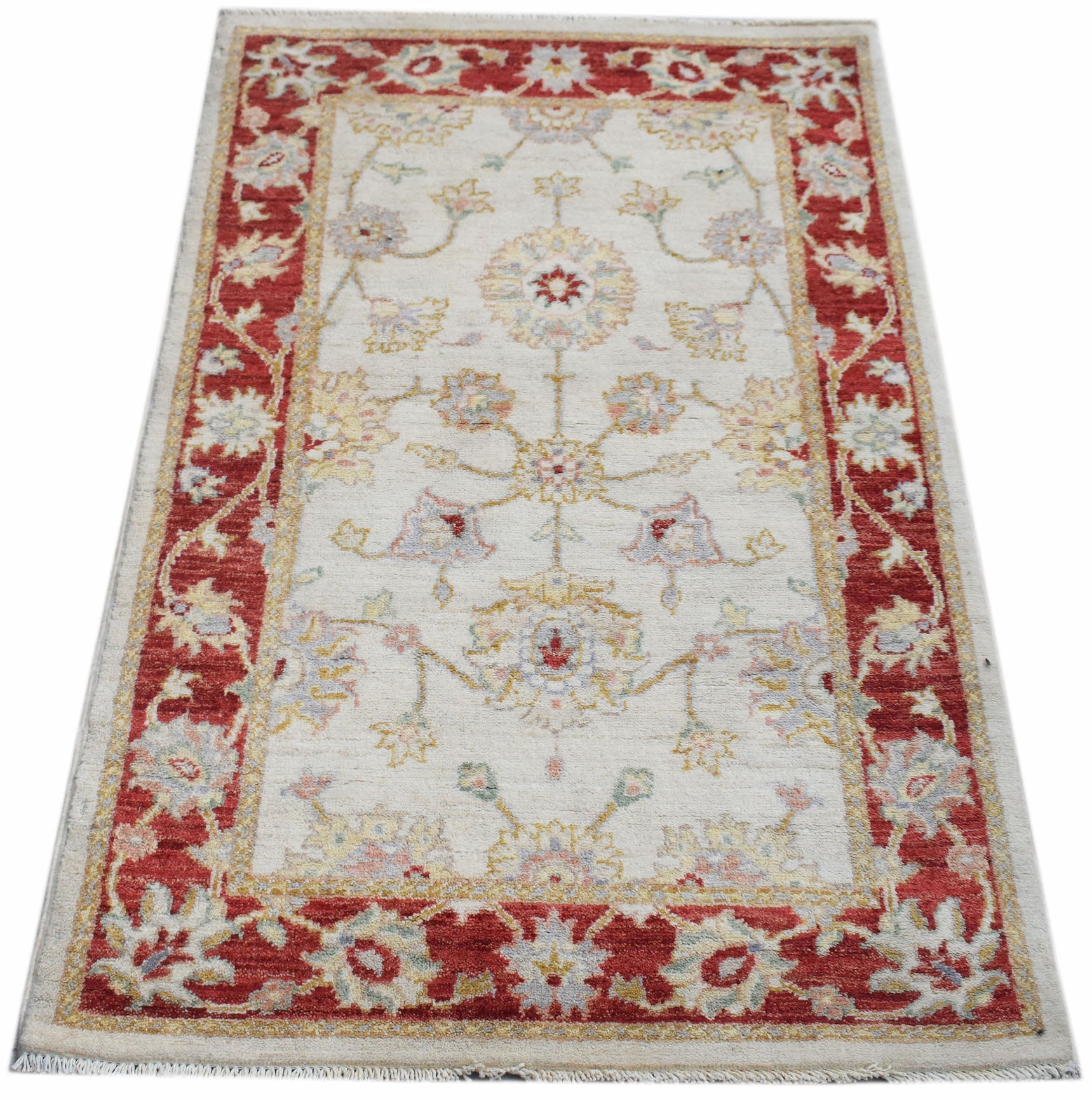 A rectangular Afghan Chobi rug featuring a floral pattern in red and cream tones.