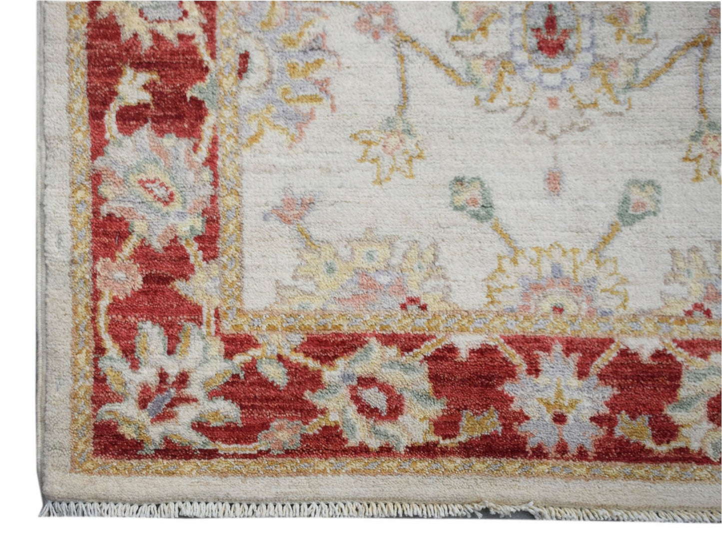 Handwoven Afghan Chobi rug featuring a traditional floral pattern in red and cream tones.