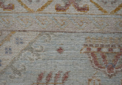 A close-up of a handwoven Afghan Chobi rug featuring traditional patterns in muted earth tones.