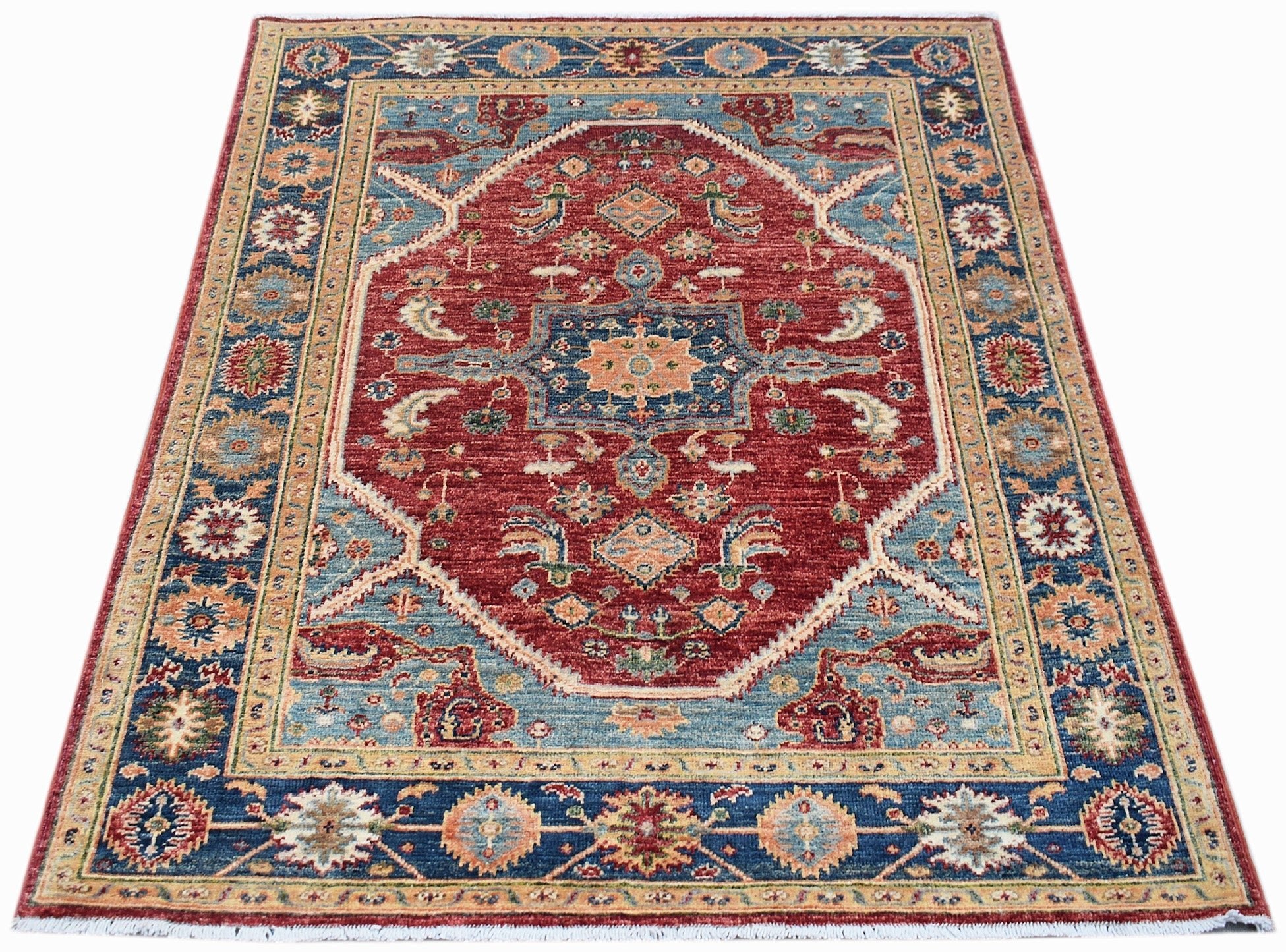 A rectangular Afghan Chobi rug featuring a central red medallion with intricate blue floral patterns.