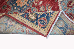 A handwoven Afghan Chobi rug featuring a traditional floral pattern in red, blue, and beige tones.