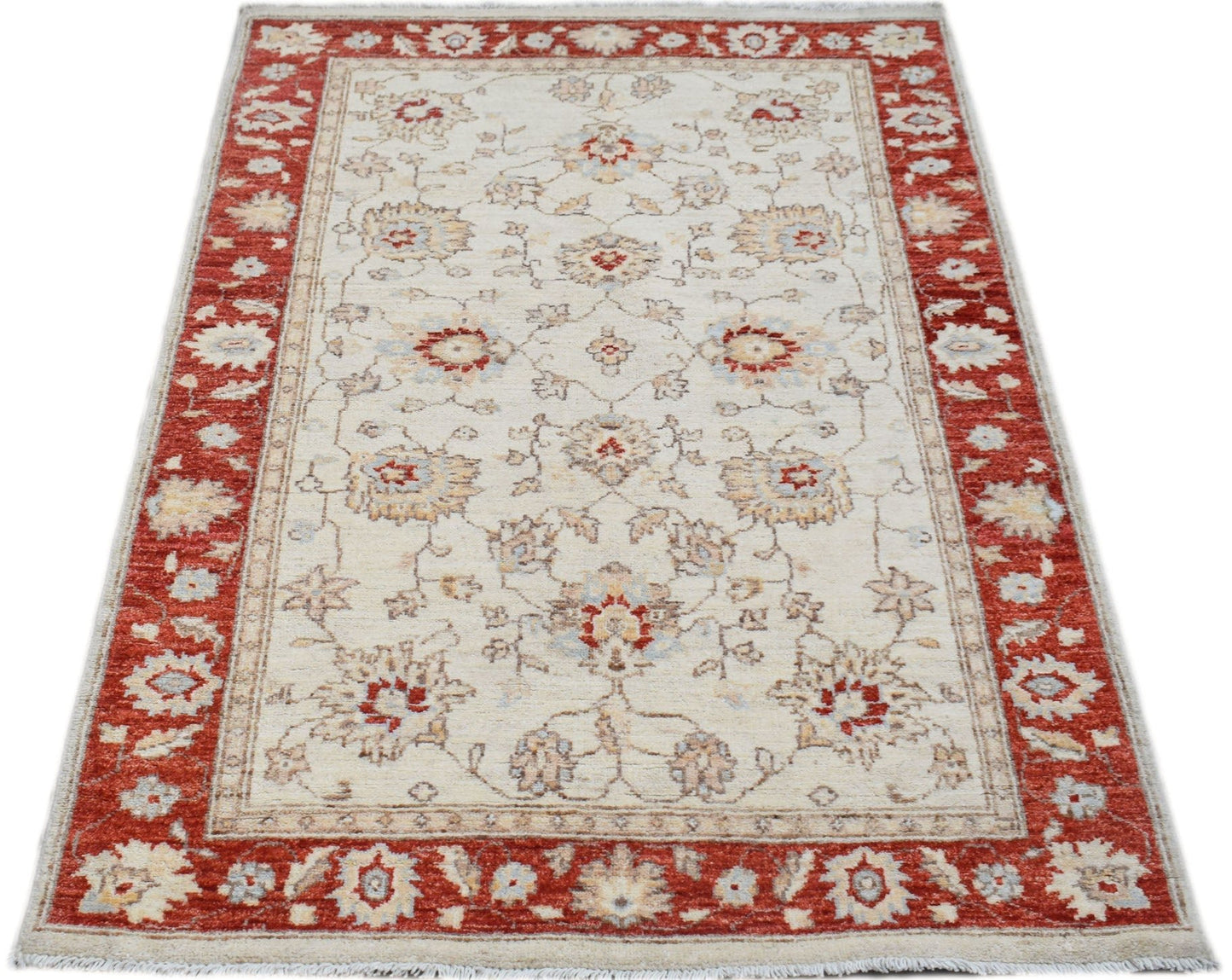 A rectangular Afghan Chobi rug featuring a cream field with floral motifs and a red border.