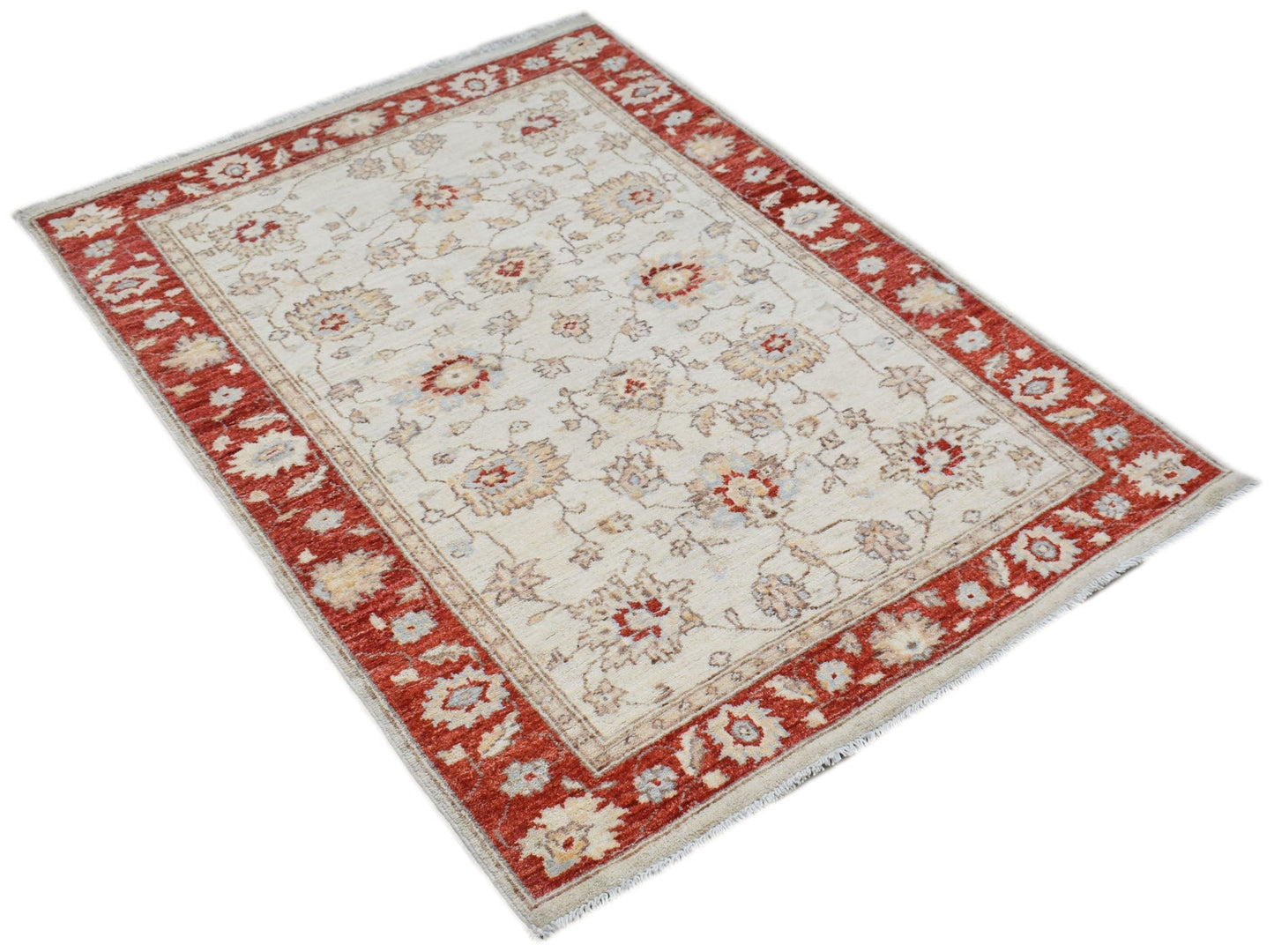 An Afghan Chobi rug featuring a cream field with floral patterns and a wide red border.