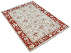 An Afghan Chobi rug featuring a cream field with floral patterns and a wide red border.