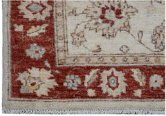 A handmade Afghan Chobi rug featuring a traditional floral pattern in red and cream tones.