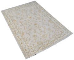 A rectangular Afghan Chobi rug featuring a traditional floral pattern in soft beige and gold tones.