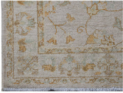 A handwoven Afghan Chobi rug featuring traditional floral patterns in soft beige and gold tones.