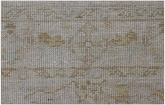 A close-up of a handwoven Afghan Chobi rug featuring a neutral palette with subtle wood-toned motifs.
