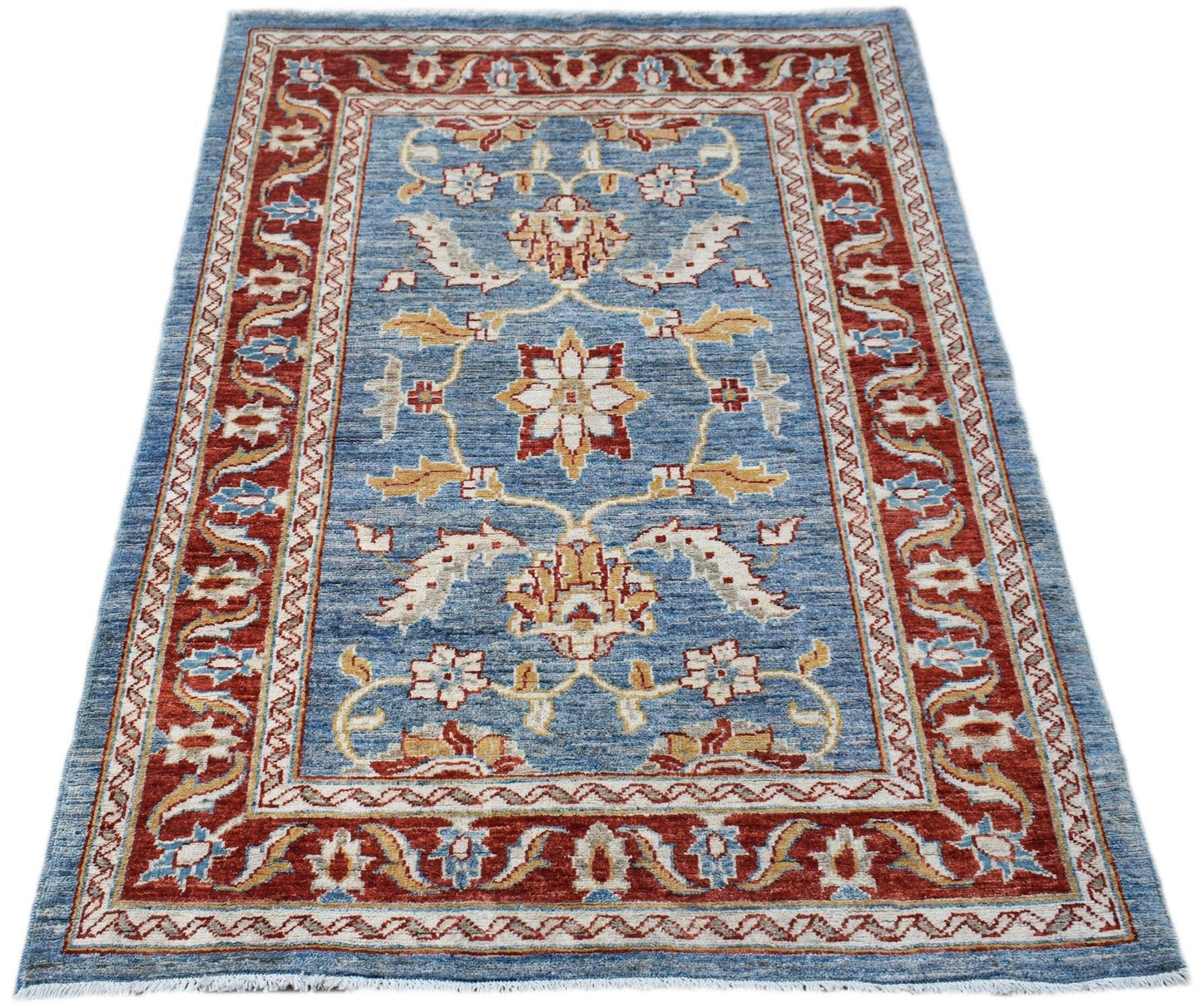 A rectangular Afghan Chobi rug featuring a floral pattern in red, blue, and cream tones.