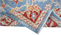 A handwoven Afghan Chobi rug featuring a traditional floral pattern in blue, red, and cream tones.