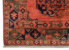 A handmade Afghan Chobi rug featuring traditional geometric patterns in red, blue, and green.