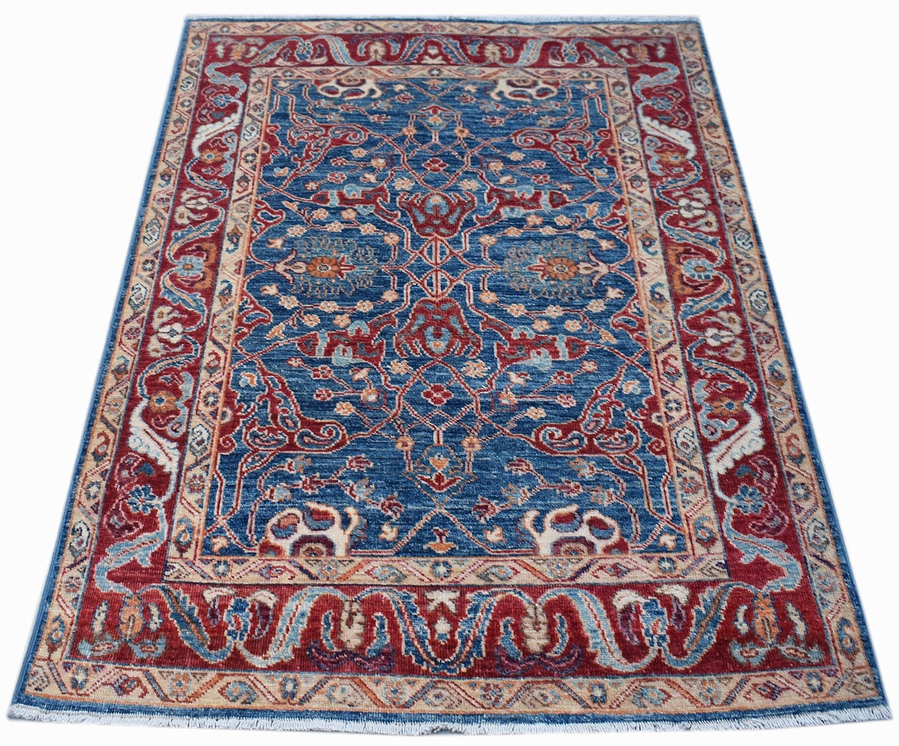 A rectangular Afghan Chobi rug featuring a traditional floral pattern in blue, red, and beige.