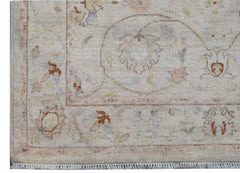 A handmade Afghan Chobi rug featuring traditional floral patterns in soft, earthy tones.