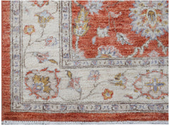 A handwoven Afghan Chobi rug featuring a floral pattern in rust, cream, and soft blue tones.
