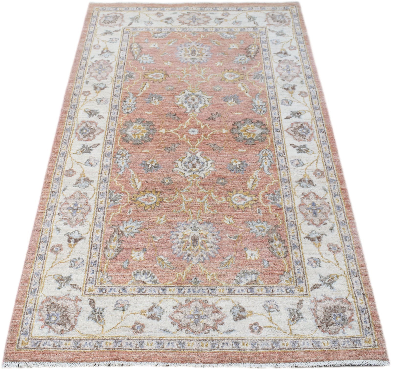 A rectangular Afghan Chobi rug featuring a floral pattern in soft pink, cream, and grey tones.