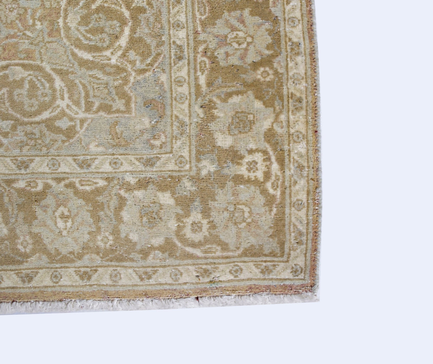 A corner view of a handwoven Afghan Chobi rug featuring traditional floral patterns in beige tones.