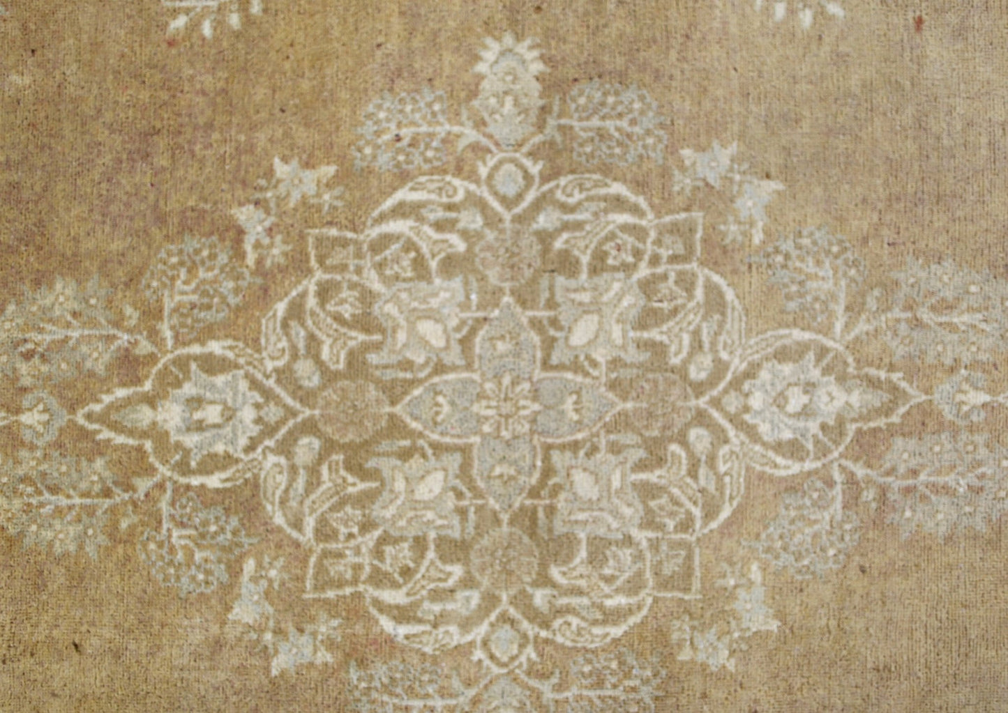 A handmade Afghan Chobi rug featuring a central floral medallion in soft beige and cream tones.