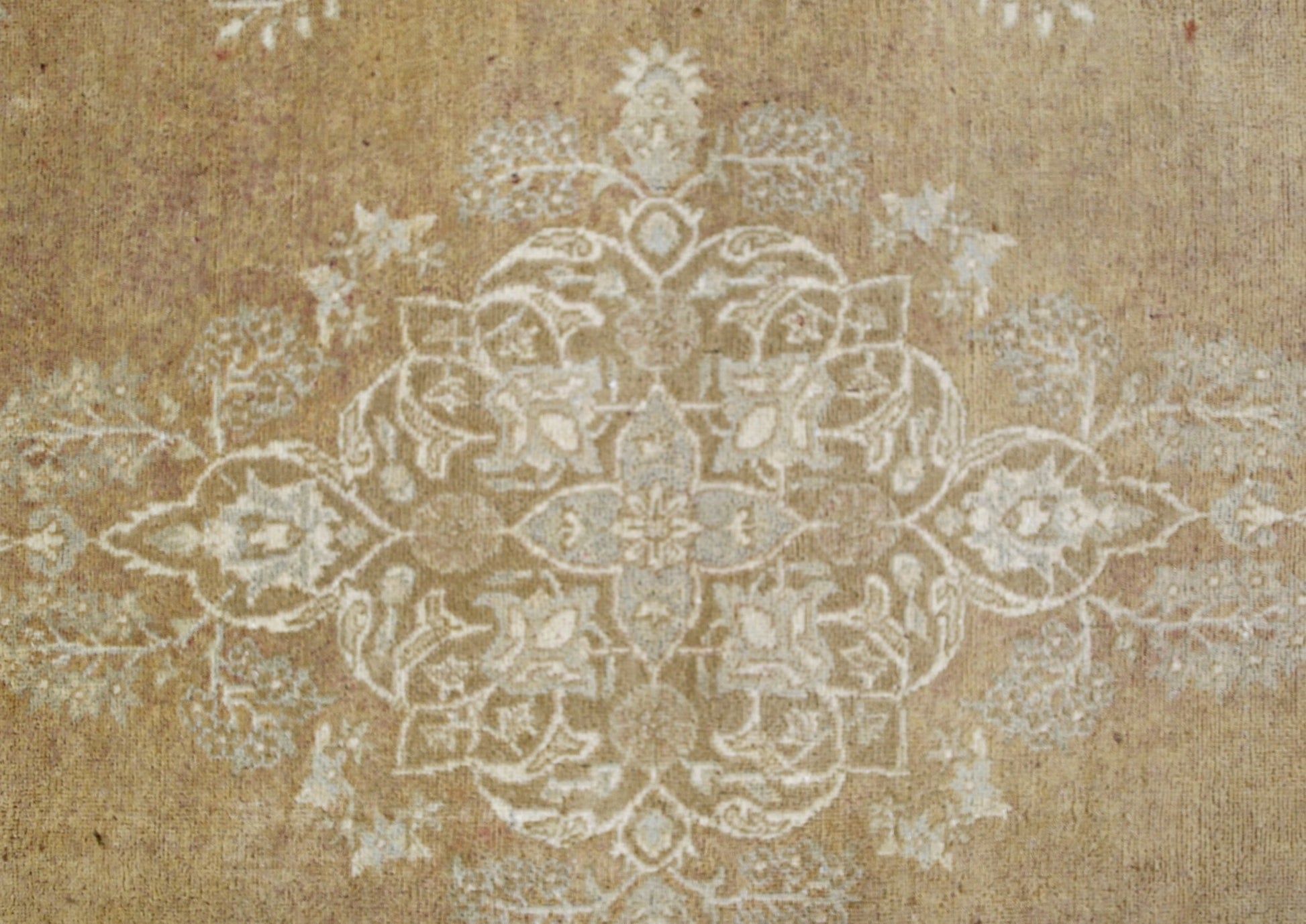 A handmade Afghan Chobi rug featuring a central floral medallion in soft beige and cream tones.