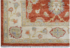 A handmade Afghan Chobi rug featuring a traditional floral pattern in rust, cream, and sage tones.