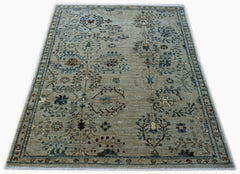 Handwoven Afghan Chobi rug featuring a traditional floral pattern in muted earth tones.