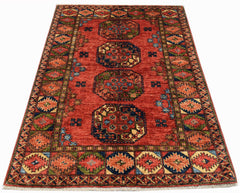 A rectangular Afghan Chobi rug featuring a red field with four large geometric medallions.