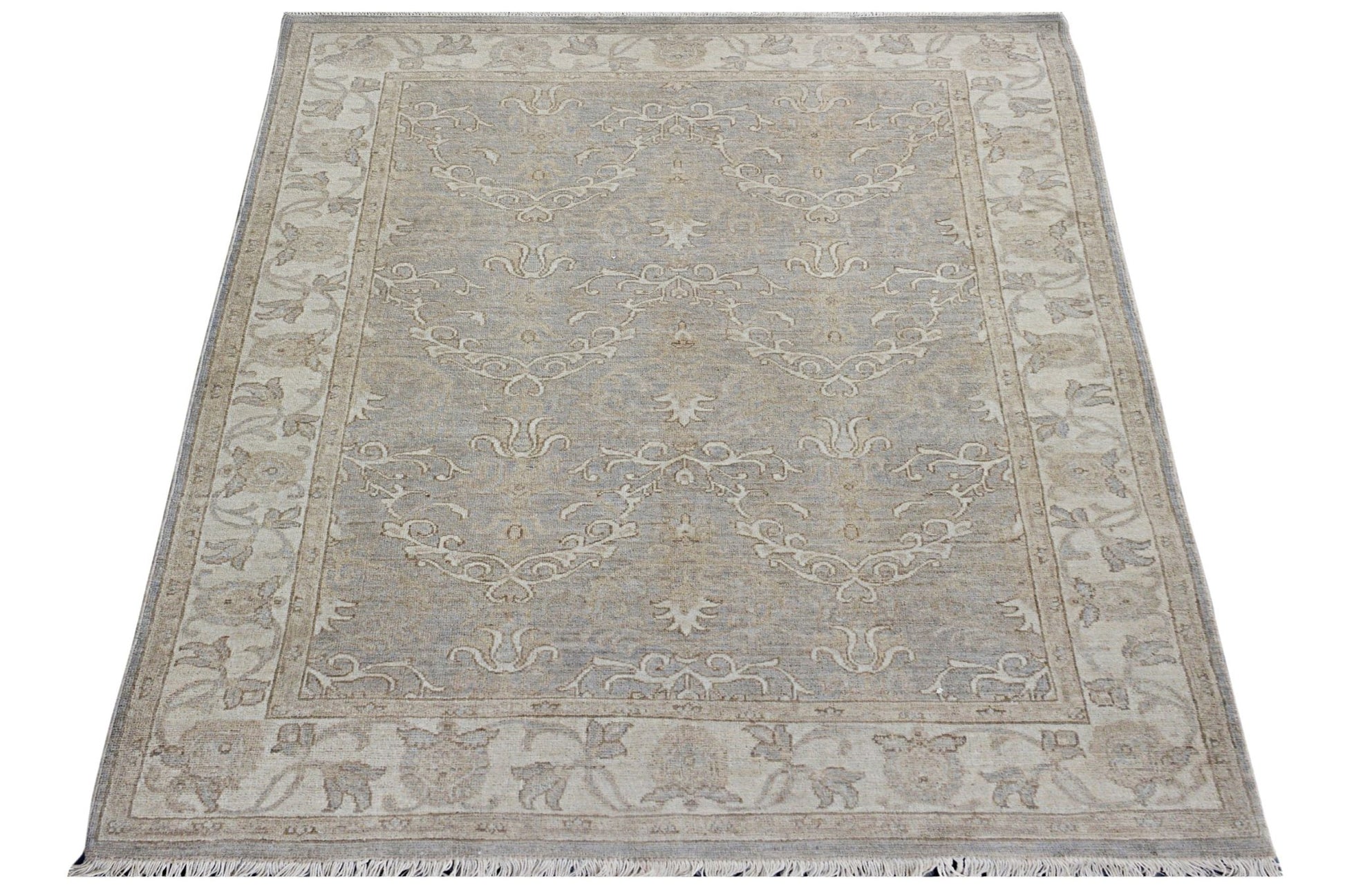 A rectangular Afghan Chobi rug featuring a traditional beige and grey floral pattern.