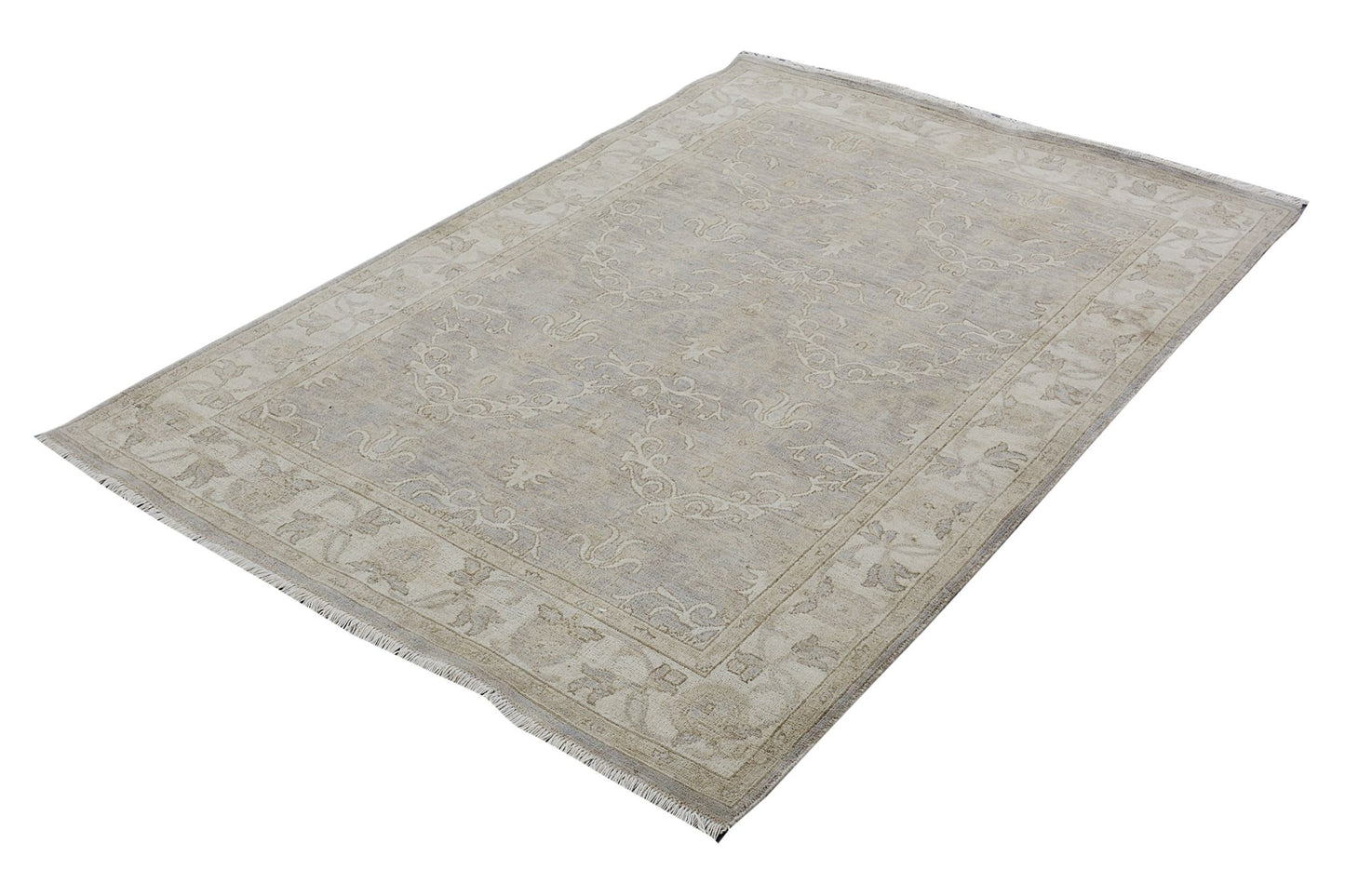 A handmade Afghan Chobi rug featuring a traditional floral pattern in neutral beige tones.
